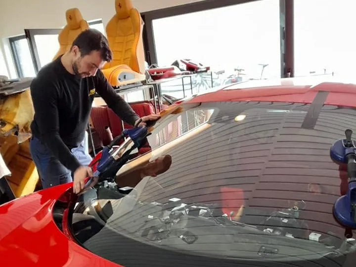 Monteur aan het werk, gefotografeerd door de voorruit heen